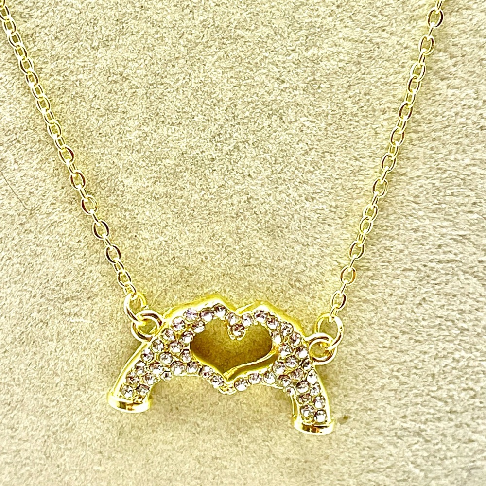 Gold Tone Necklace with Crystal Hands Making a Heart Pendant. 19 inches